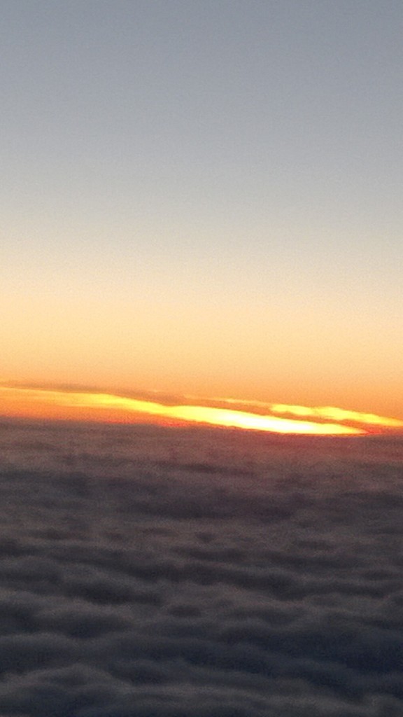 A sea of clouds against a fiery sky. (View from an airplane.)