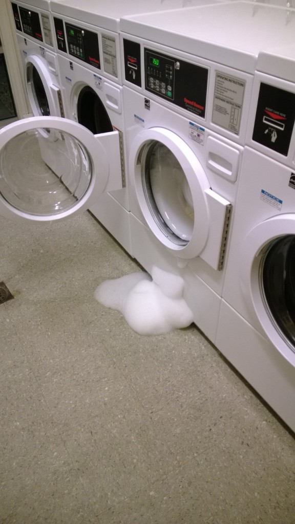 A washing machine with so much soap, it looks very fluffy.