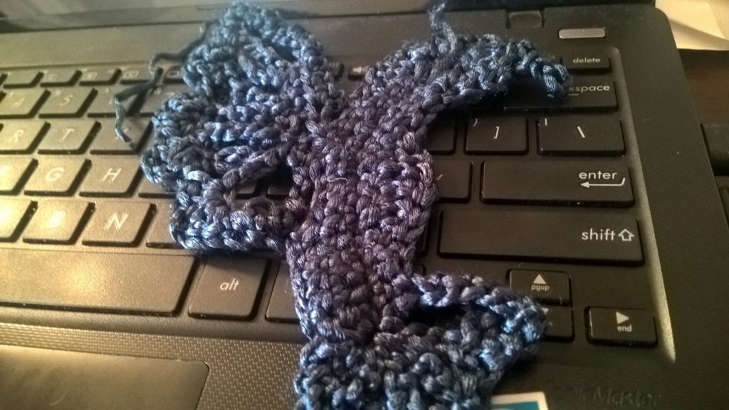 crocheted hummingbird on a keyboard.